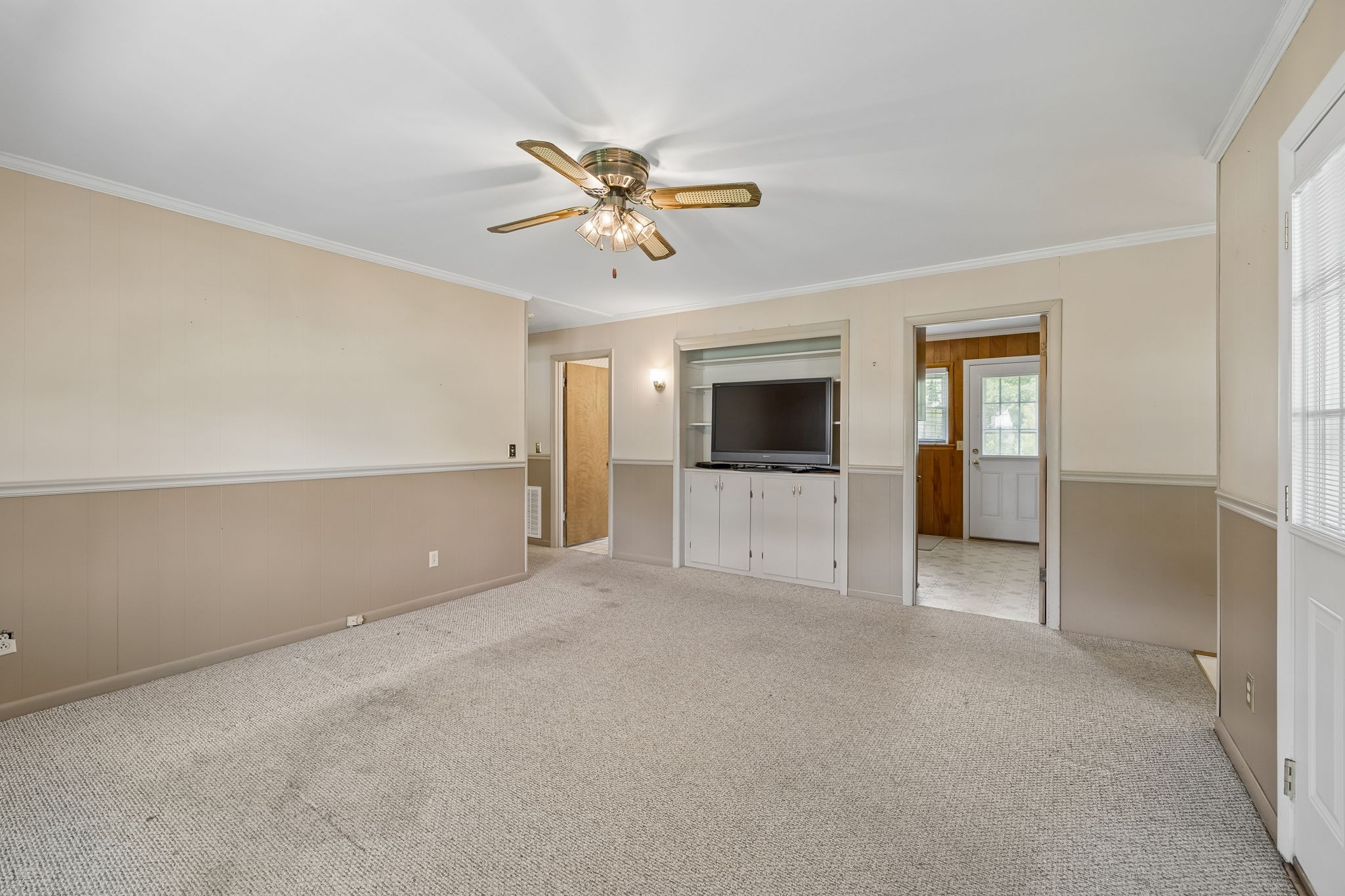 708 Hickory Street Centerville, TN 37033 - Photo 13 of 57 a view of an empty room with a window and a kitchen