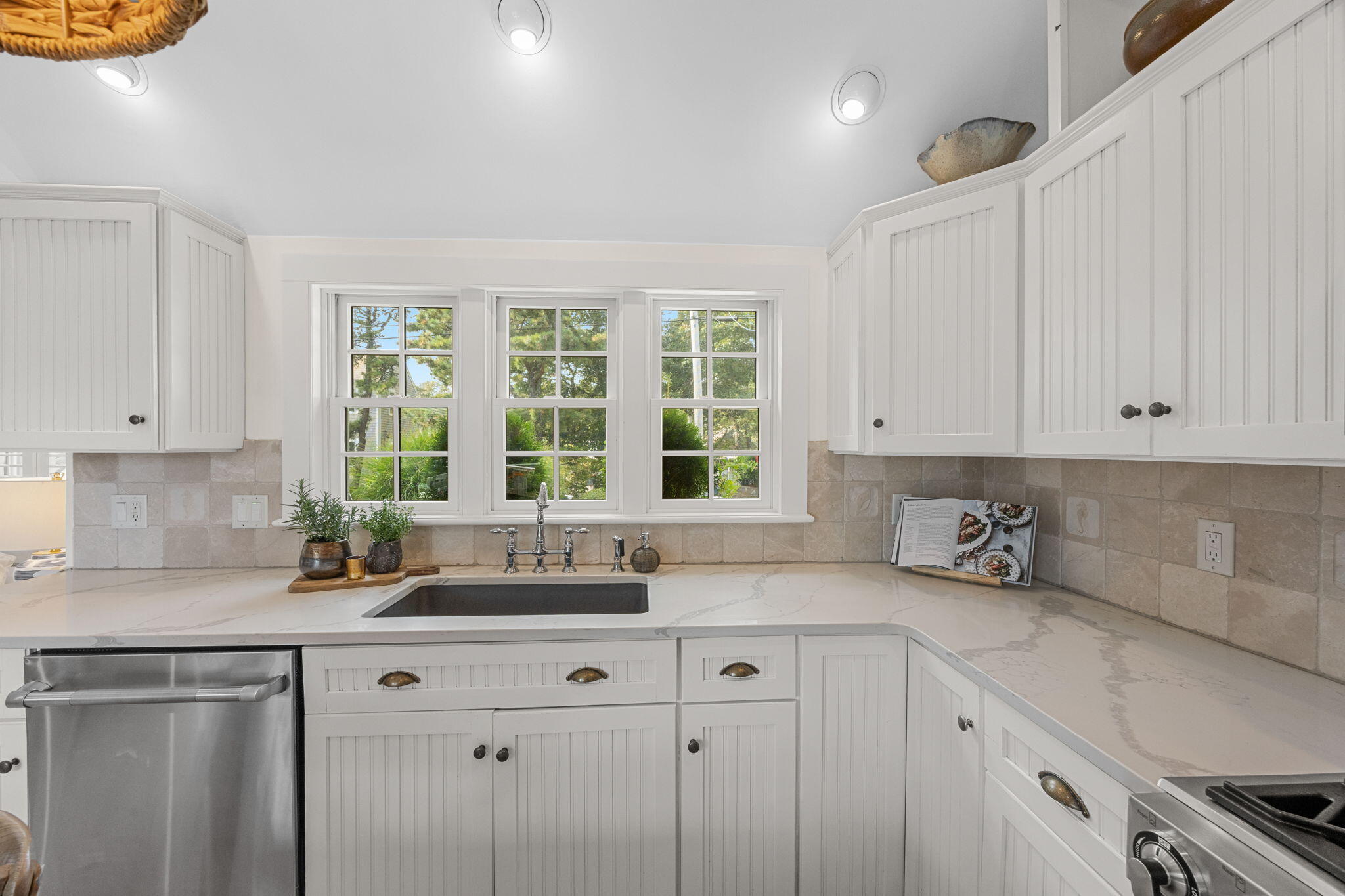 291 Ridgevale Road Chatham, MA 02633 - Photo 30 of 53 a kitchen with stainless steel appliances granite countertop a sink a stove and a granite counter tops with white cabinets