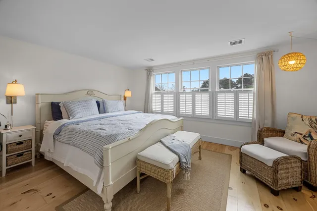 a bedroom with a large bed and a window