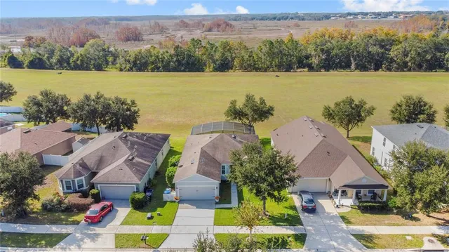 an aerial view of houses with yard