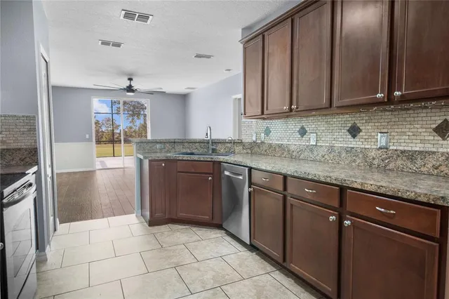 a kitchen with a sink a stove cabinets and refrigerator