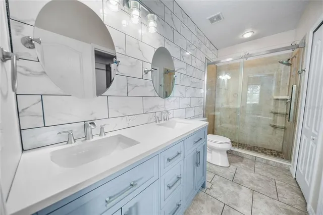 a bathroom with a sink toilet and shower