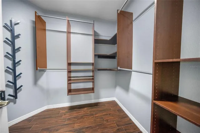 a view of walk in closet with empty racks