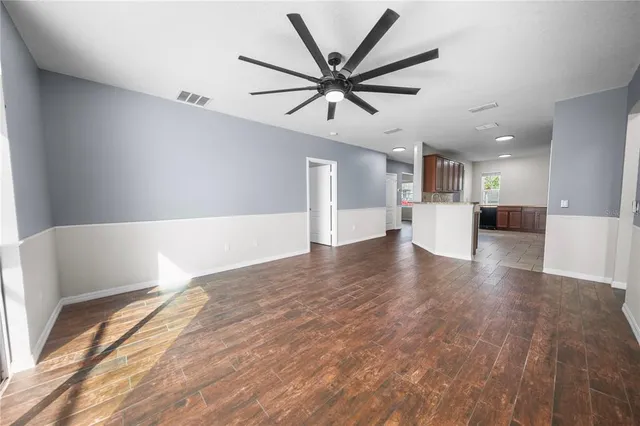 a view of empty room with wooden floor