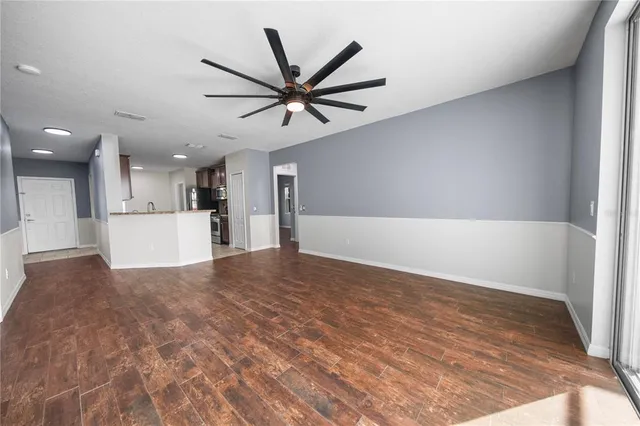 a view of a kitchen with a sink and a refrigerator