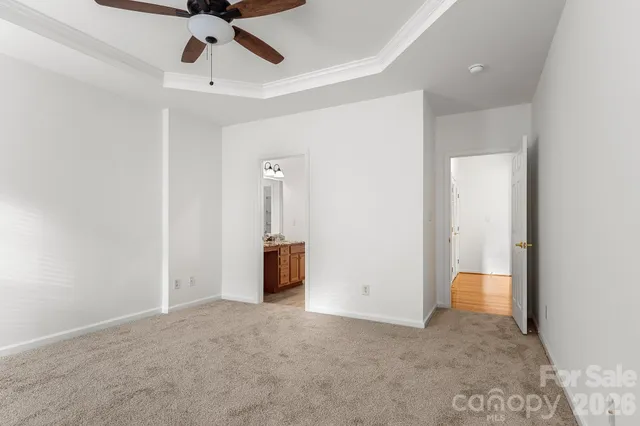 a view of an empty room and a ceiling fan