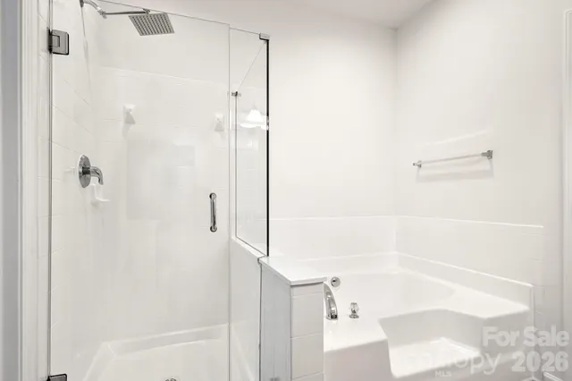 a bathroom with a bathtub and shower