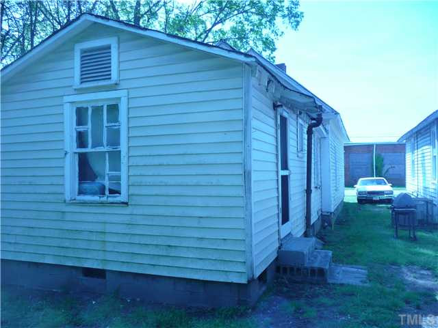 209 Bragg Street Raleigh, NC 27601 - Photo 3 of 4 a view of a small house with a backyard