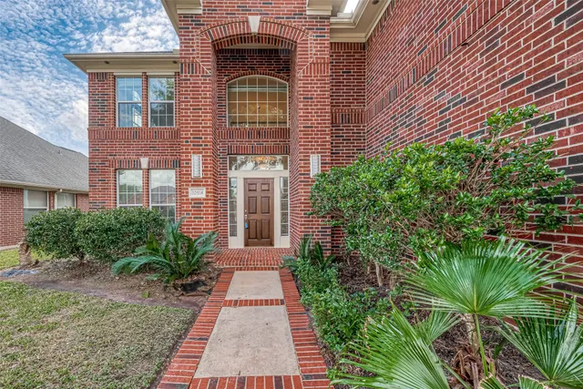 a front view of a house with plants