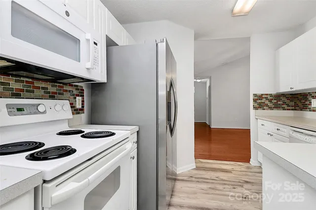 a kitchen with a stove and a refrigerator