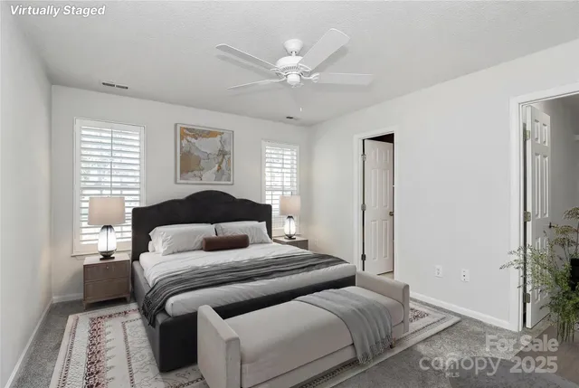 a bedroom with a large bed and a chandelier