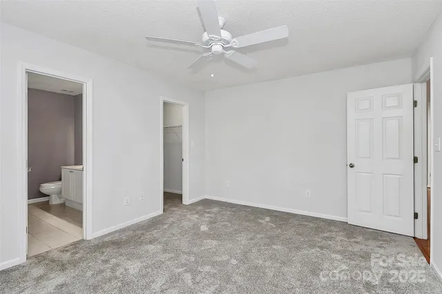 a view of an empty room and a bathroom