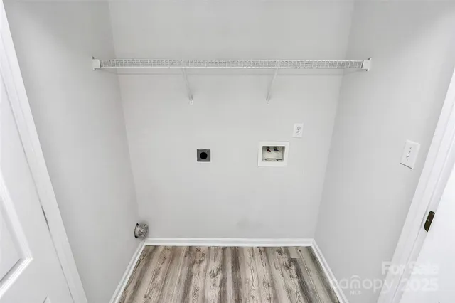 a view of a room with wooden floor and entryway