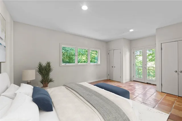 a bedroom with a large bed and a window