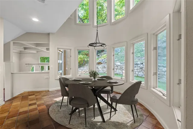 a view of a dining room with furniture window and outside view