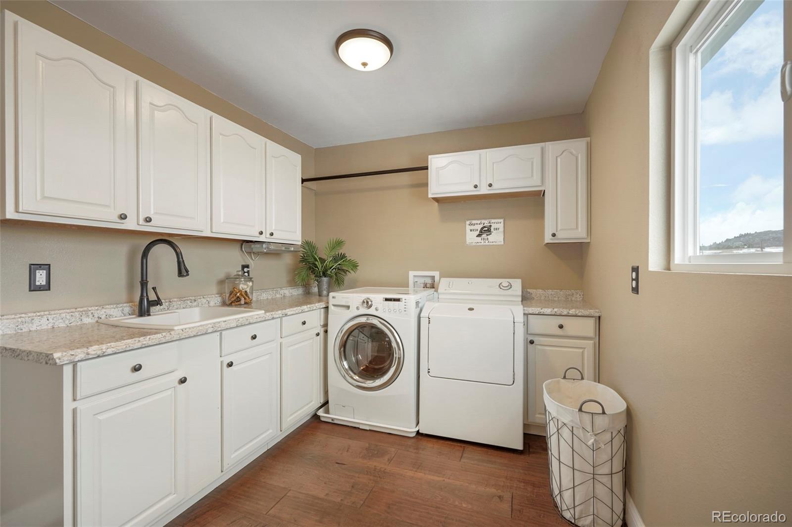 14929 South Spring Valley Road Larkspur, CO 80118 - Photo 14 of 40 a utility room with dryer and washer