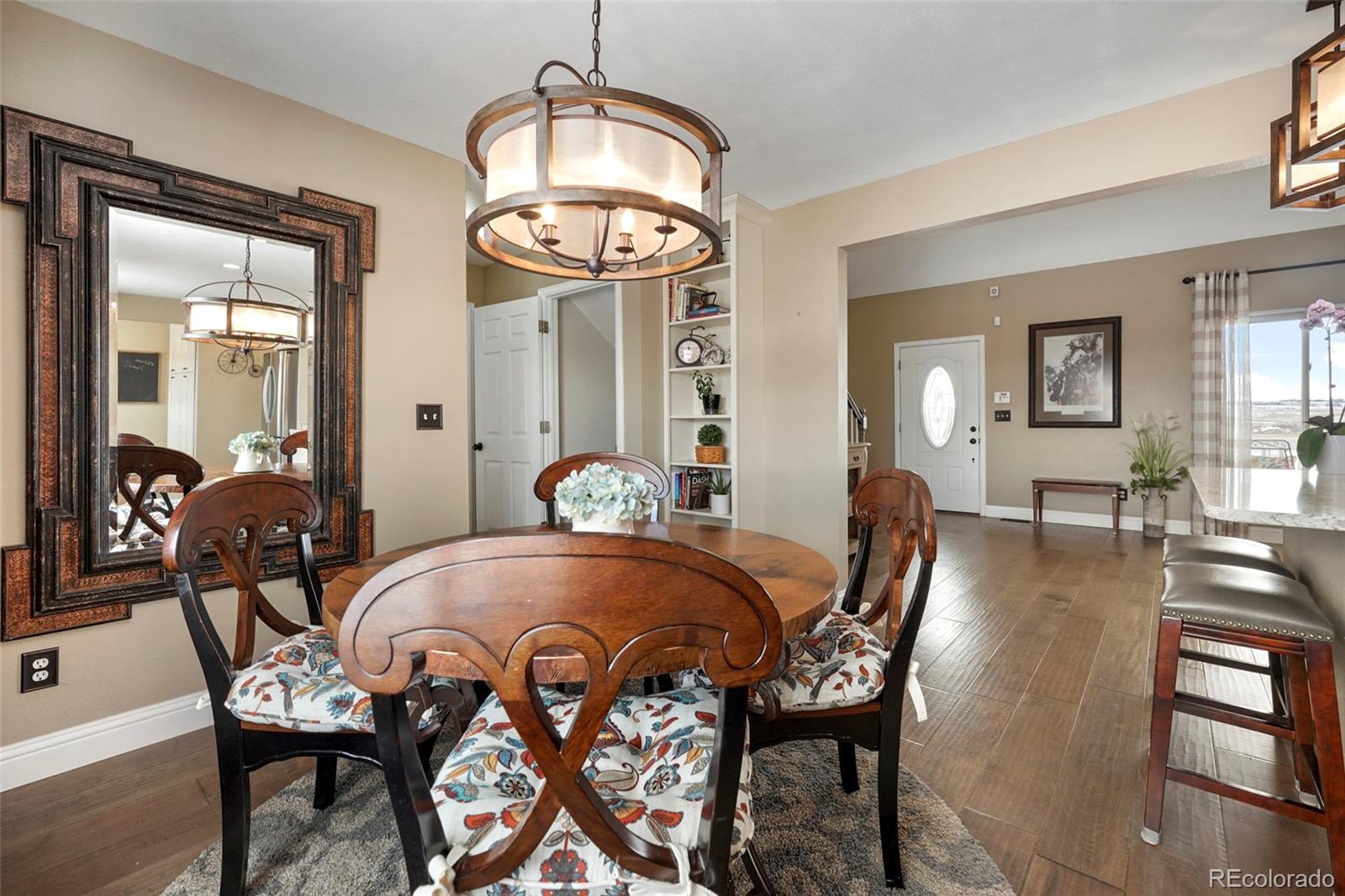 14929 South Spring Valley Road Larkspur, CO 80118 - Photo 15 of 40 a view of a dining room with furniture and wooden floor