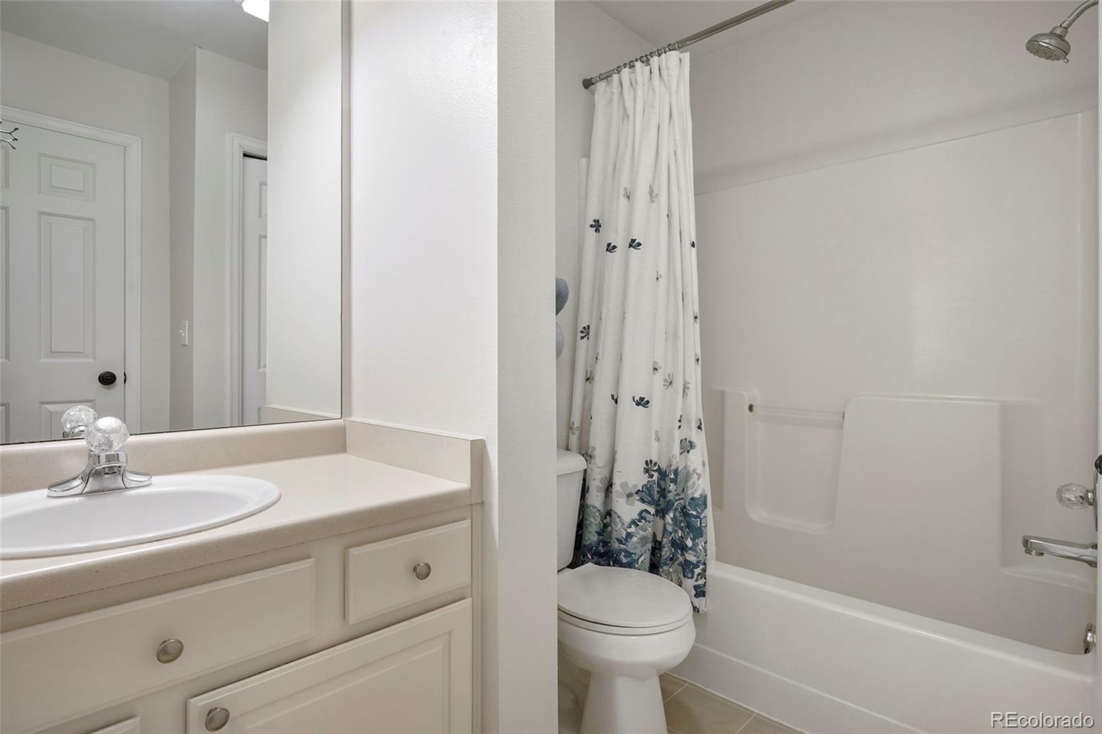 14929 South Spring Valley Road Larkspur, CO 80118 - Photo 23 of 40 a bathroom with a sink toilet and shower