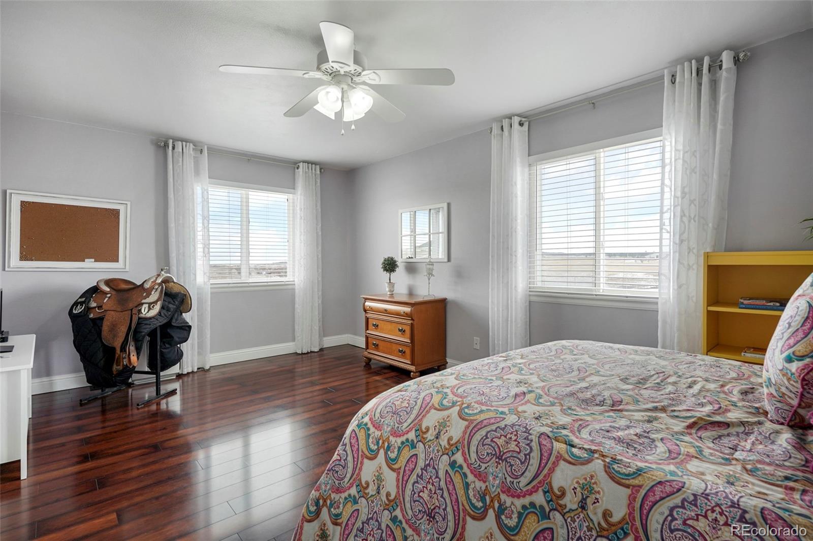 14929 South Spring Valley Road Larkspur, CO 80118 - Photo 24 of 40 a bedroom with a bed and wooden floor