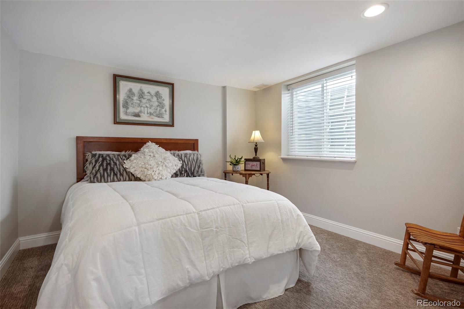 14929 South Spring Valley Road Larkspur, CO 80118 - Photo 28 of 40 a bedroom with a bed and a window