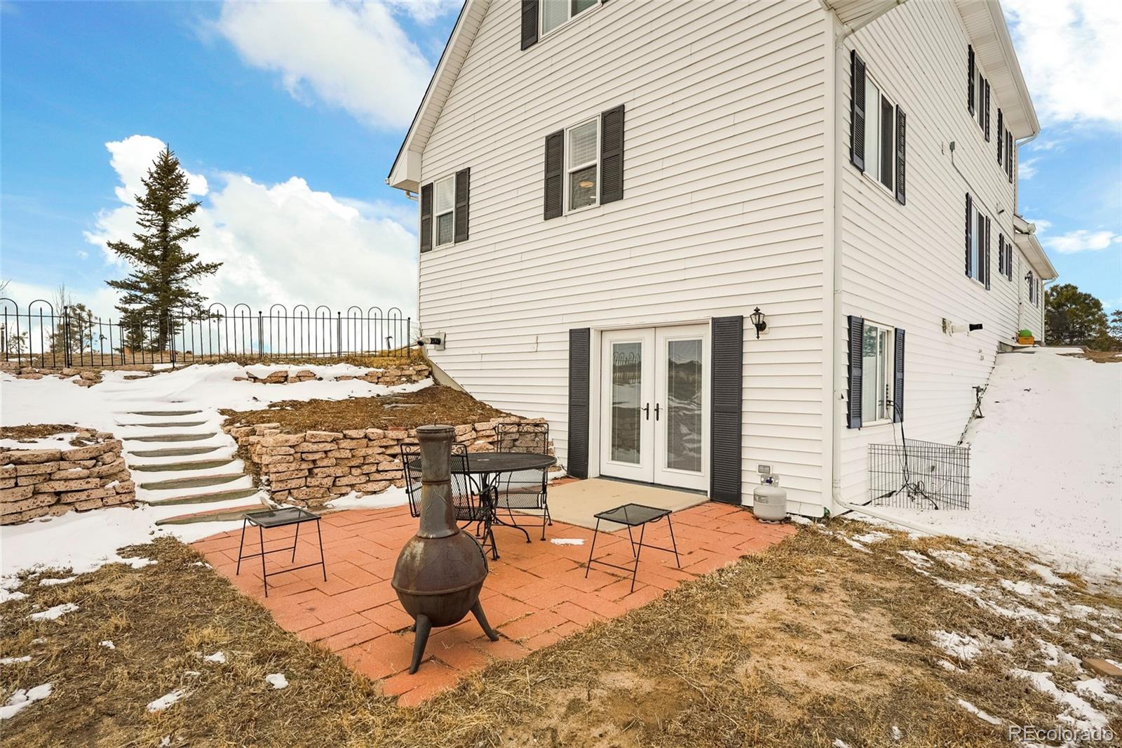 14929 South Spring Valley Road Larkspur, CO 80118 - Photo 34 of 40 a view of a terrace with chairs