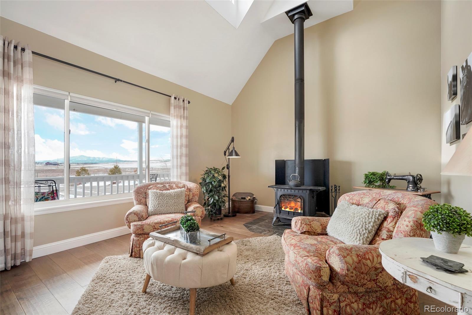 14929 South Spring Valley Road Larkspur, CO 80118 - Photo 4 of 40 a living room with furniture and a large window