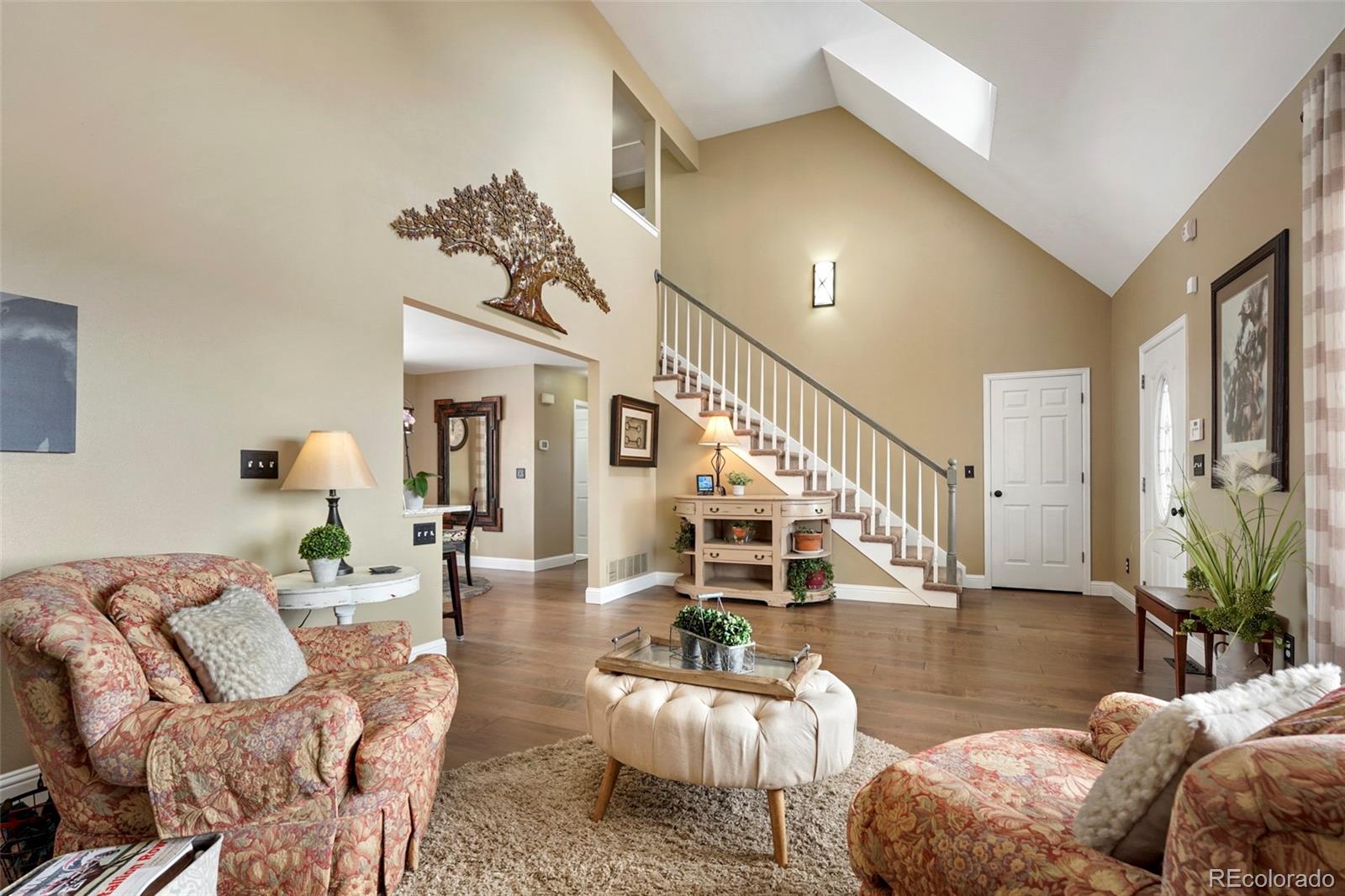 14929 South Spring Valley Road Larkspur, CO 80118 - Photo 5 of 40 a living room with furniture and wooden floor