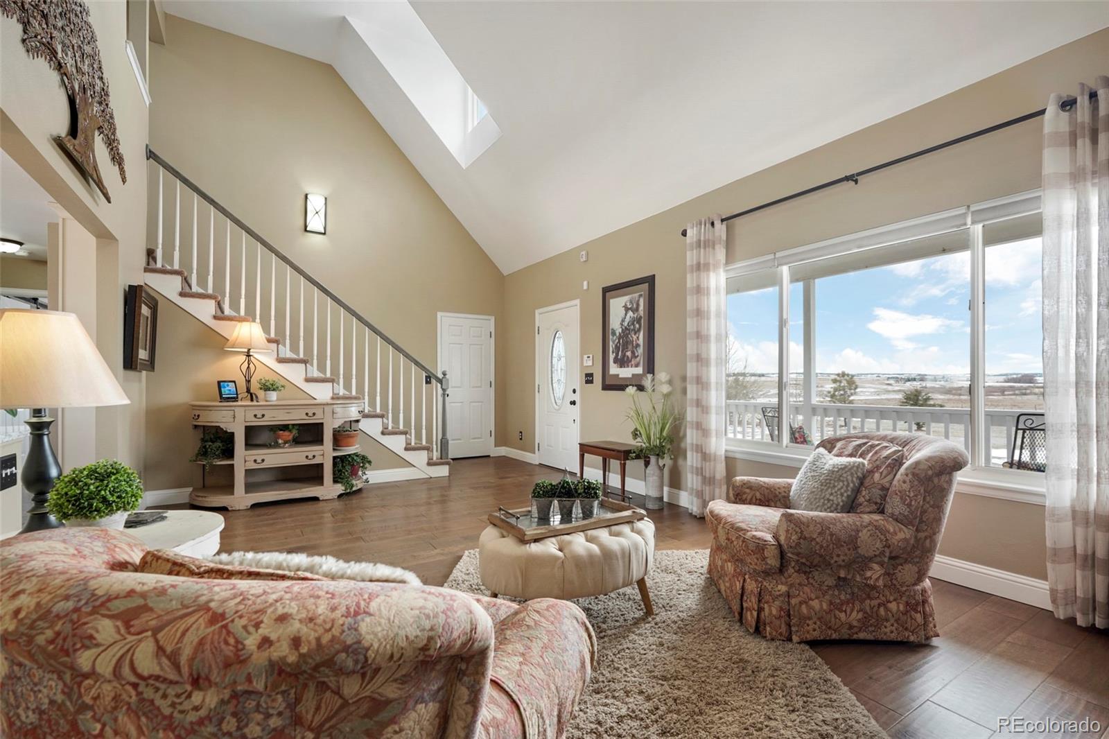 14929 South Spring Valley Road Larkspur, CO 80118 - Photo 6 of 40 a living room with furniture and a potted plant