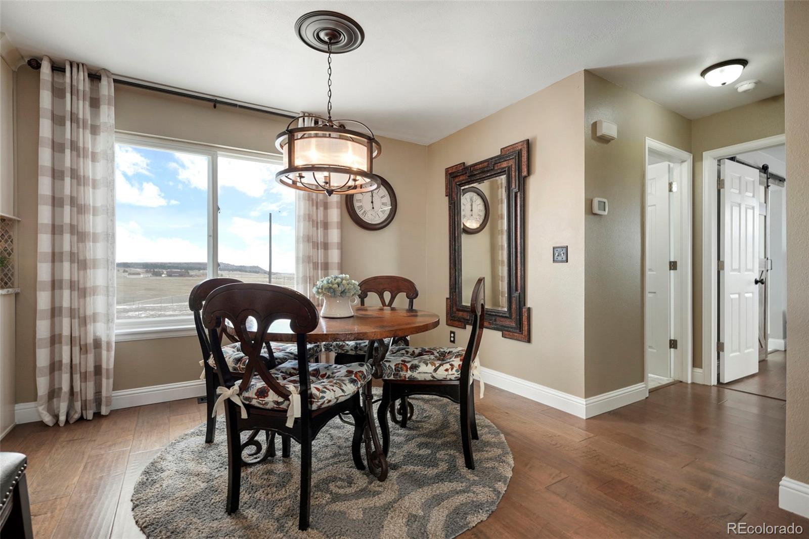 14929 South Spring Valley Road Larkspur, CO 80118 - Photo 7 of 40 a dining room with furniture and window