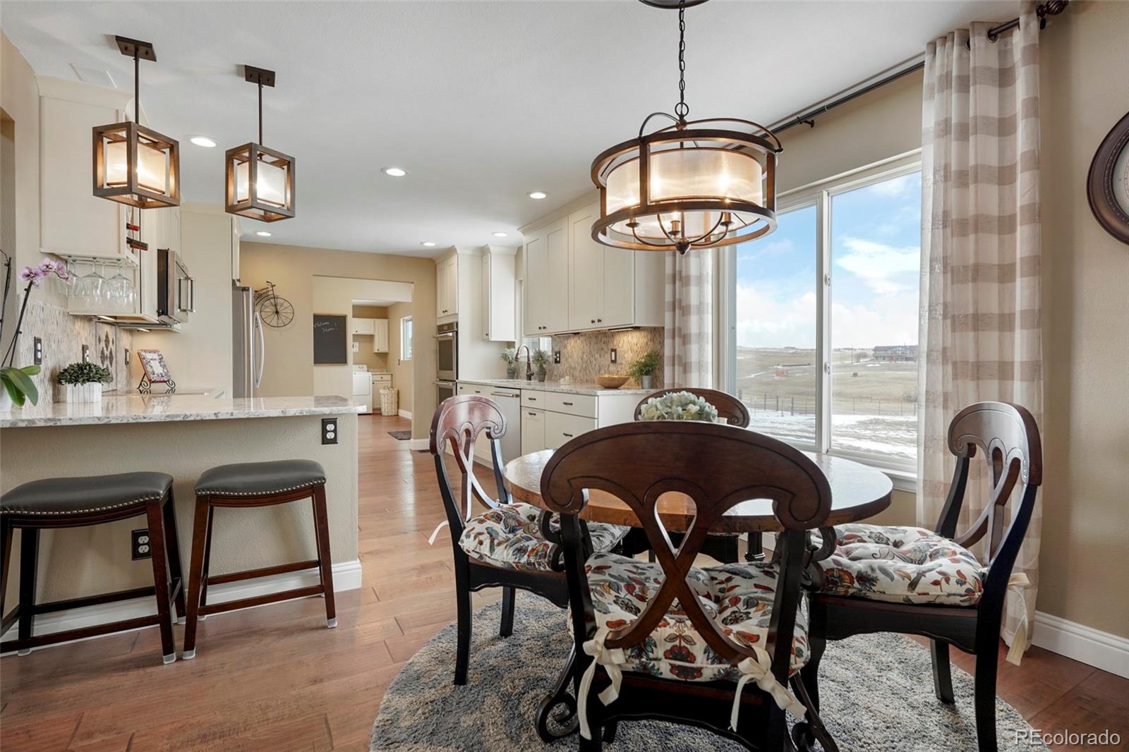 14929 South Spring Valley Road Larkspur, CO 80118 - Photo 8 of 40 a dining room with furniture a chandelier and window
