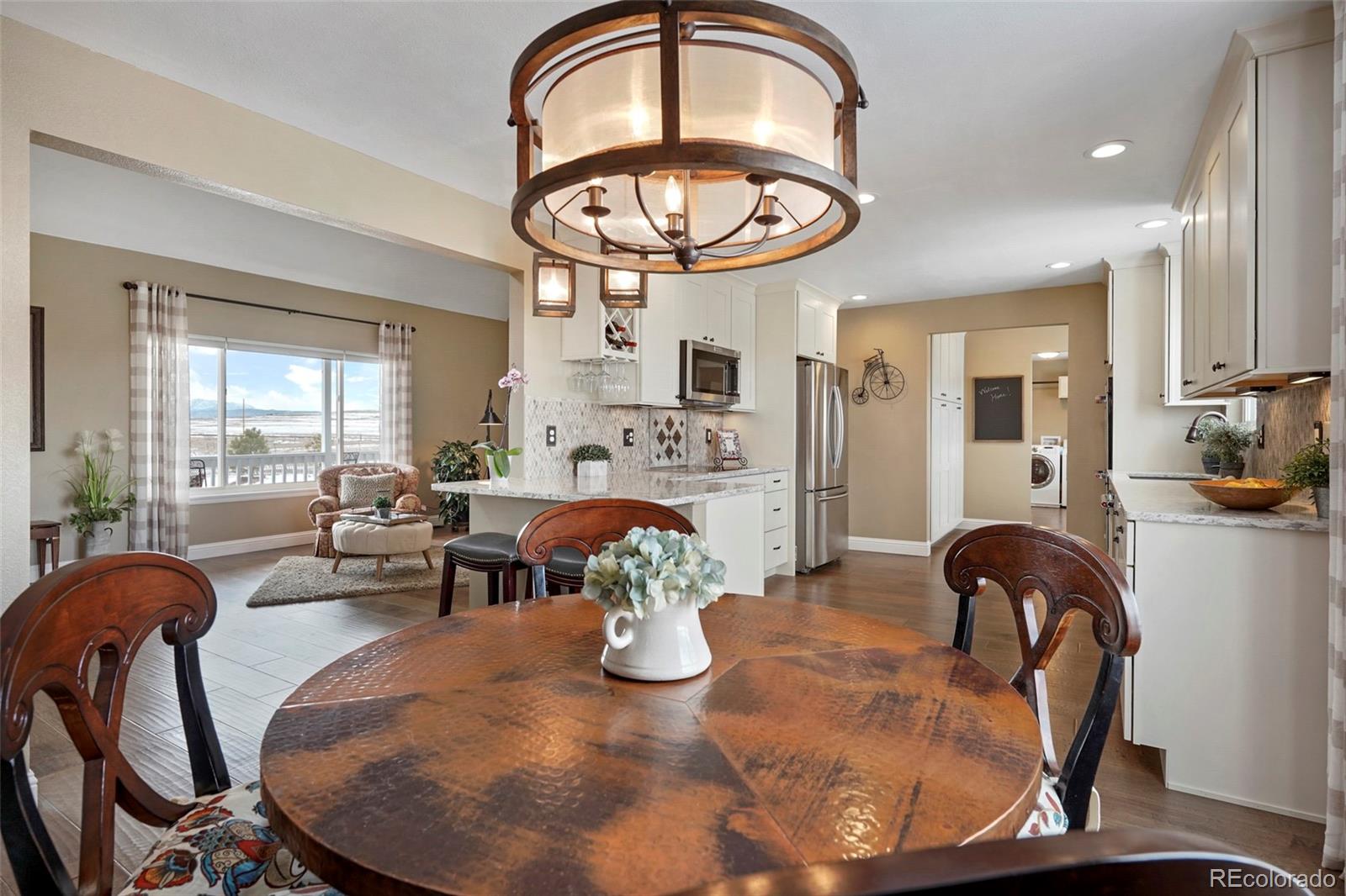 14929 South Spring Valley Road Larkspur, CO 80118 - Photo 9 of 40 a view of a dining room with furniture window and wooden floor