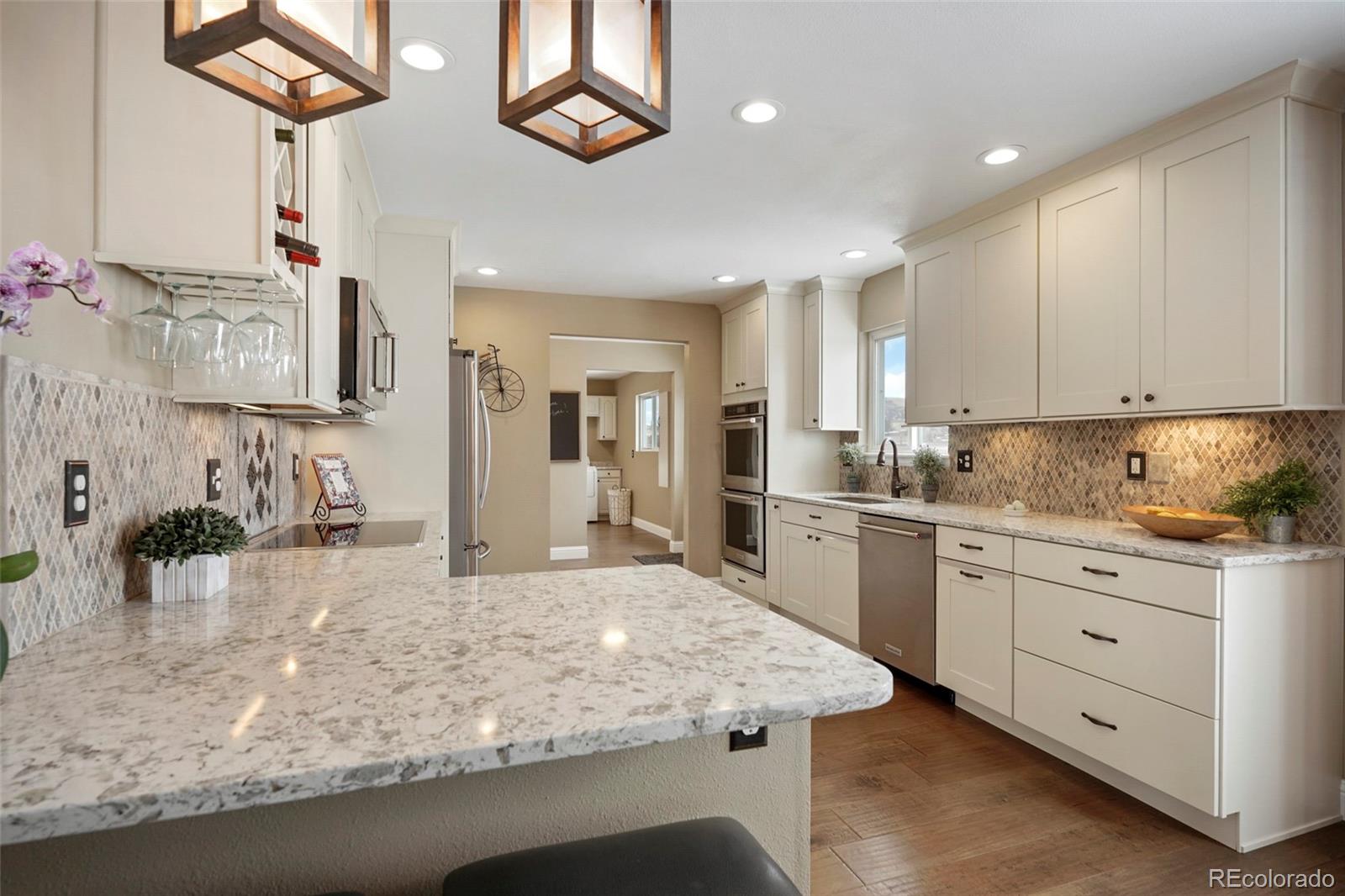 14929 South Spring Valley Road Larkspur, CO 80118 - Photo 10 of 40 a kitchen with sink stove and cabinets