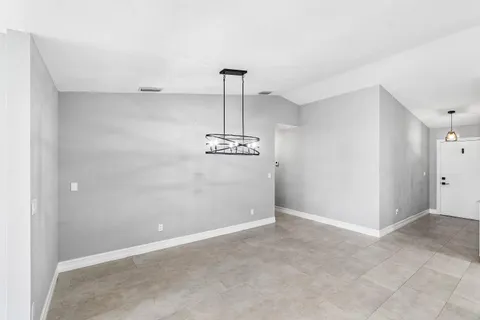a view of a chandelier fan in big room