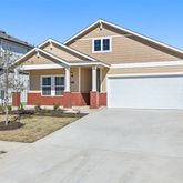 a front view of a house with garage and parking