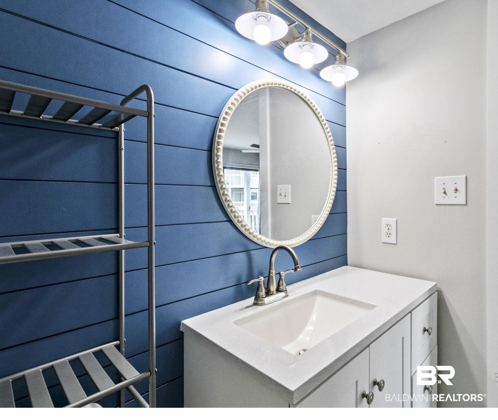 25861 Canal Road, Unit 77 Orange Beach, AL 36561 - Photo 24 of 48 Bathroom with vanity and wood walls