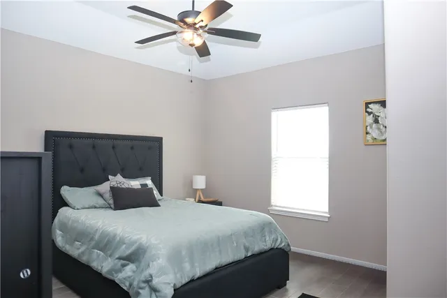 a bedroom with a bed and a window