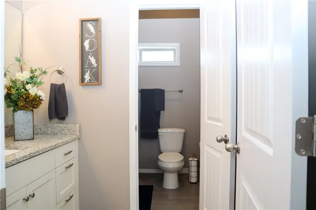 a white toilet sitting next to a bathroom sink