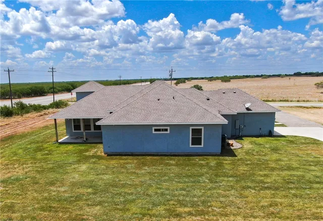 a aerial view of a house with a yard