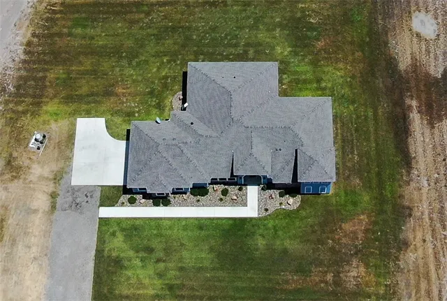 an aerial view of a house with yard swimming pool and outdoor seating
