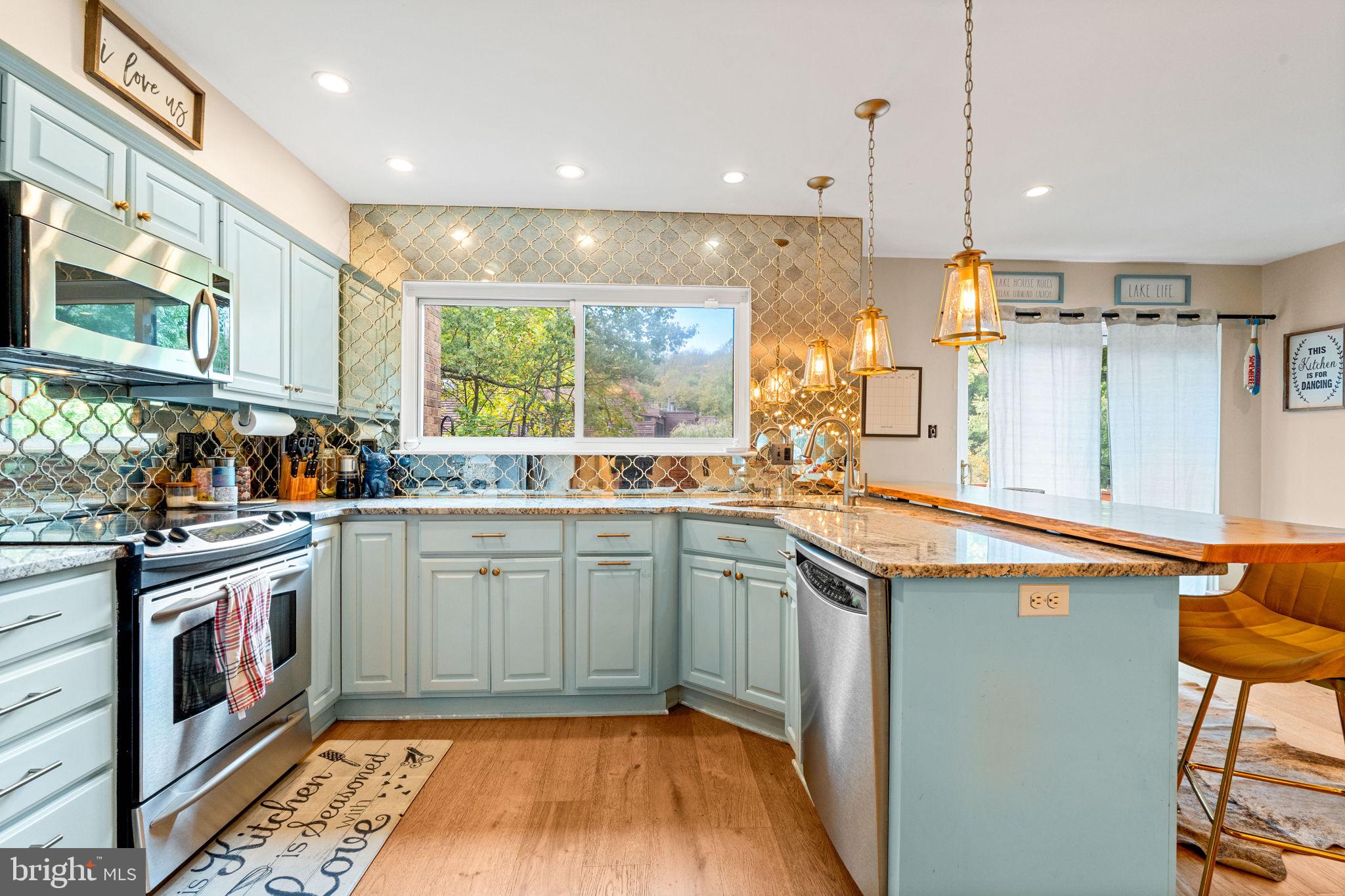 2012 Swans Neck Way Reston, VA 20191 - Photo 13 of 36 a kitchen with stainless steel appliances granite countertop a sink and stove top oven