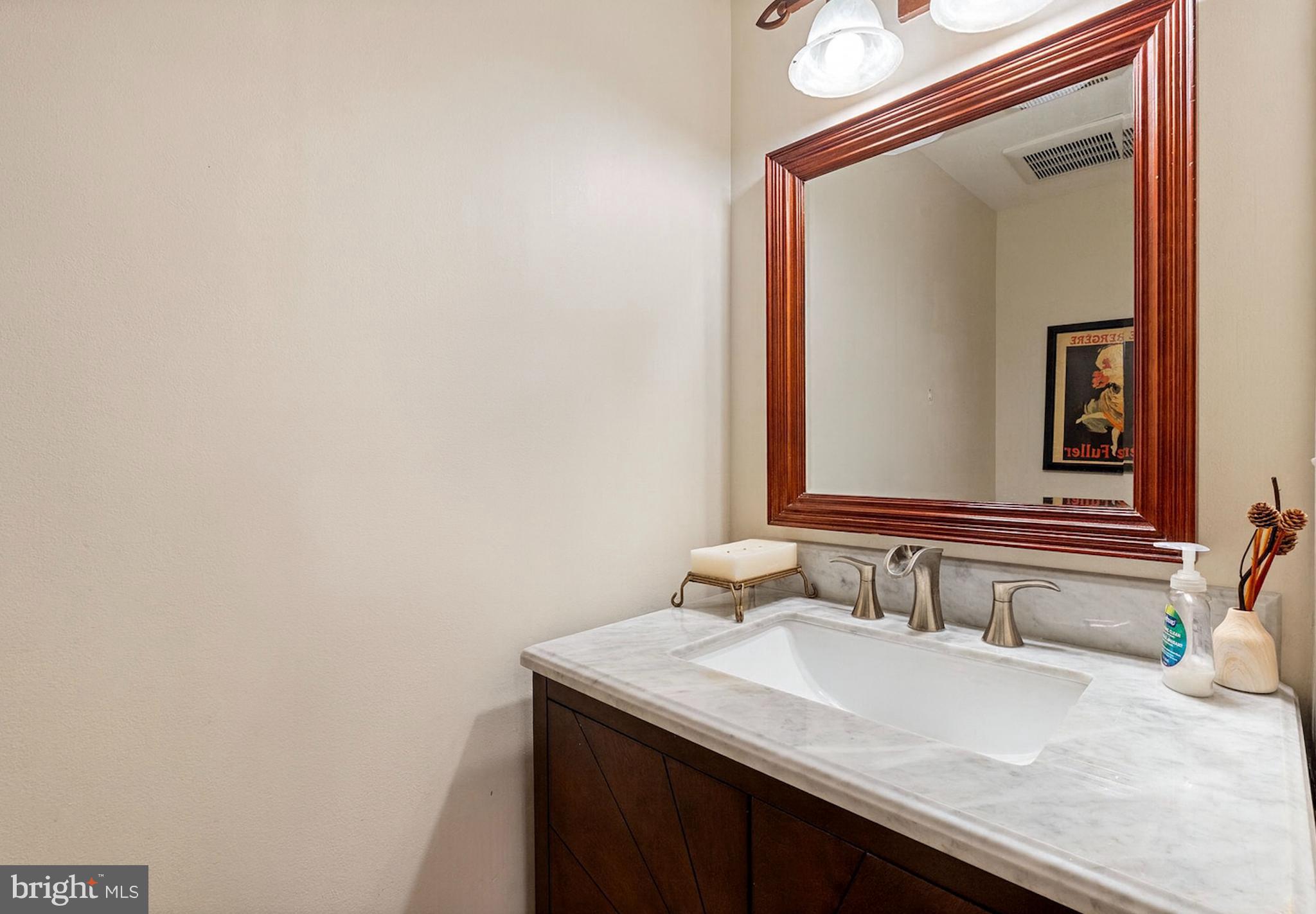 2012 Swans Neck Way Reston, VA 20191 - Photo 14 of 36 a bathroom with a granite countertop sink and a mirror
