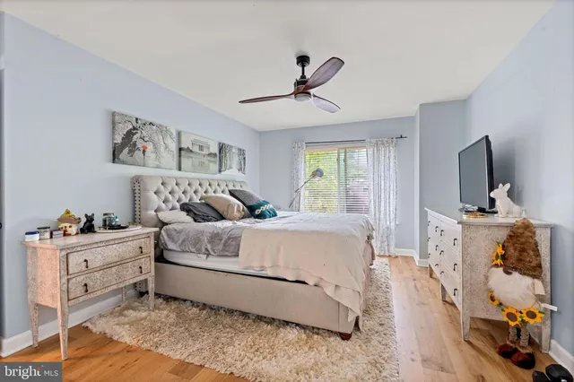 a spacious bedroom with a bed and a flat screen tv