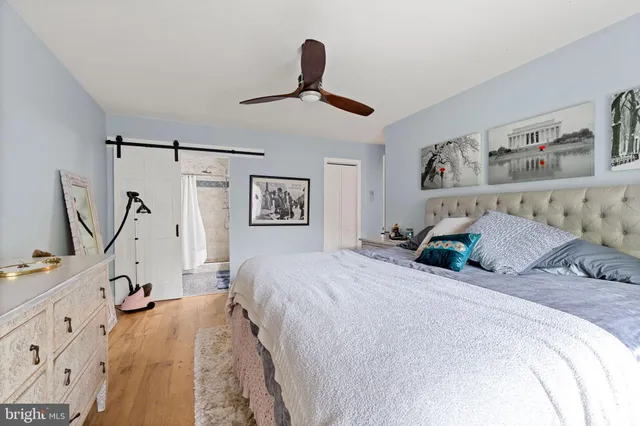 a bedroom with a large bed and a window