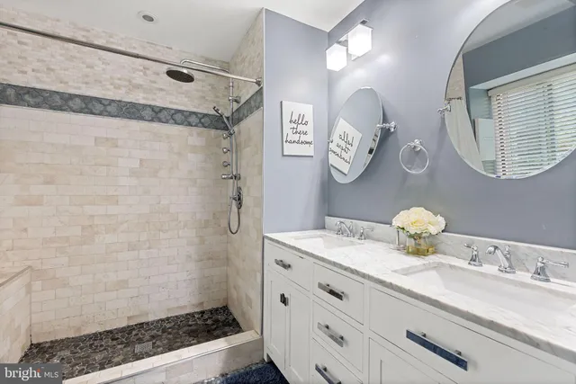 a bathroom with a granite countertop sink mirror and vanity