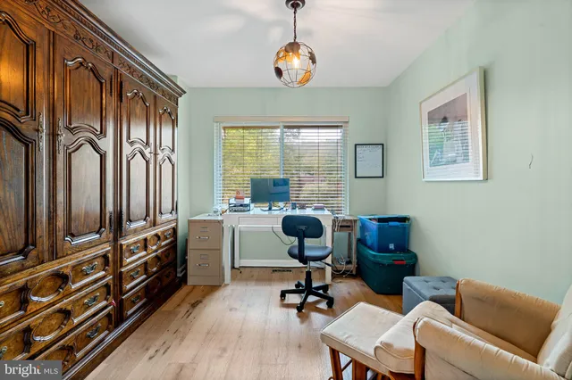 a view of a livingroom with workspace and a window