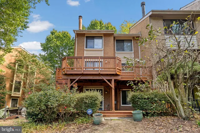 a view of a house with a small yard and plants