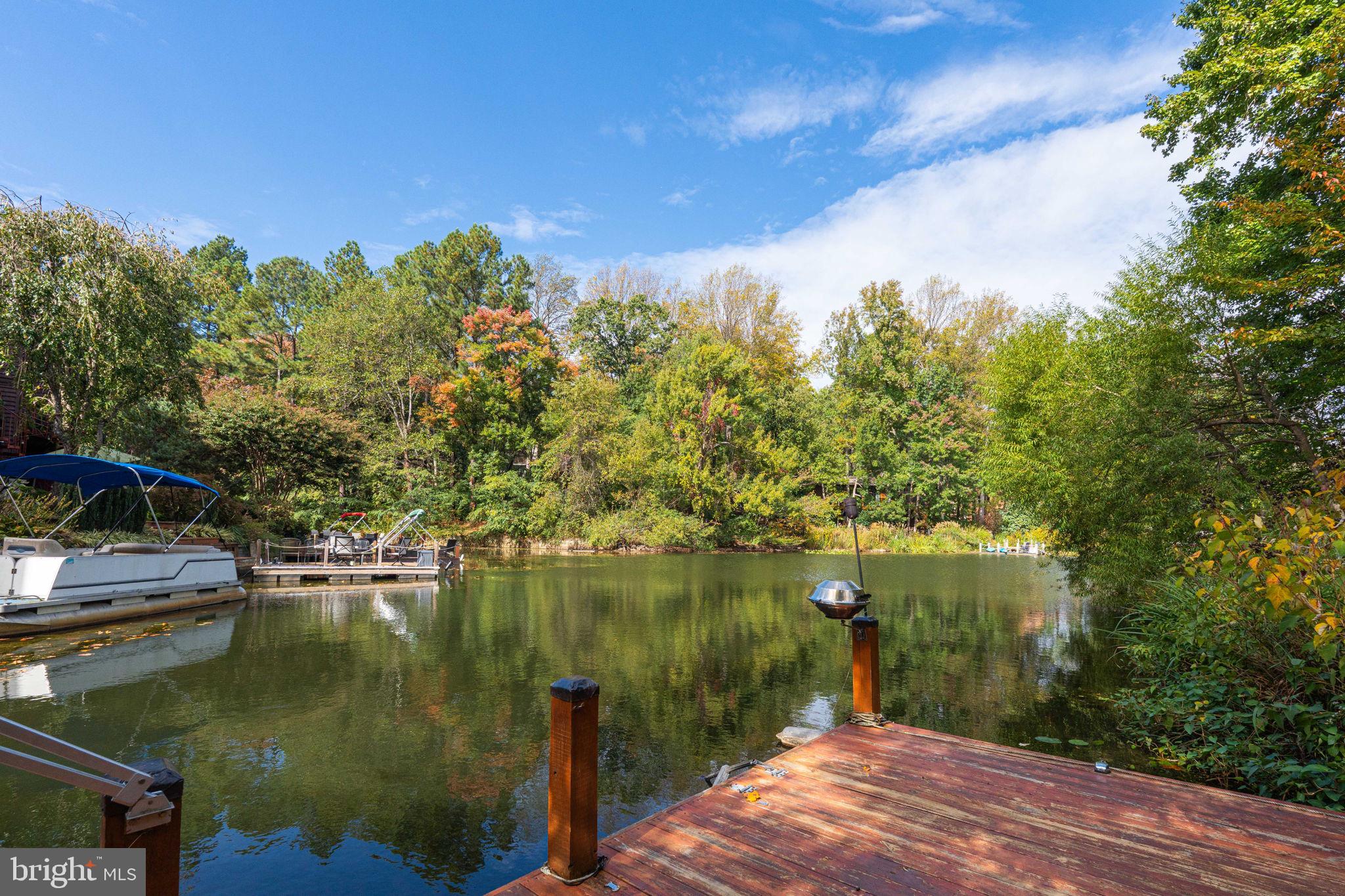 2012 Swans Neck Way Reston, VA 20191 - Photo 35 of 36 a view of a lake with a house in the background