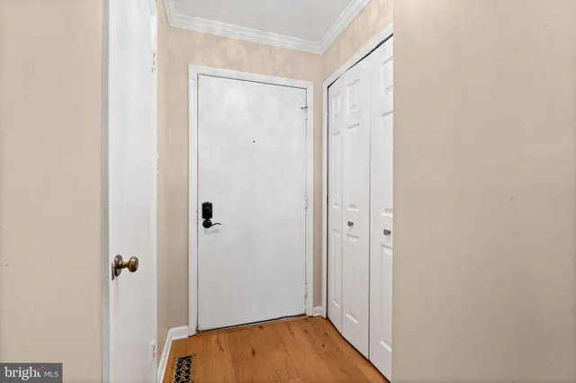 a view of a hallway with wooden floor