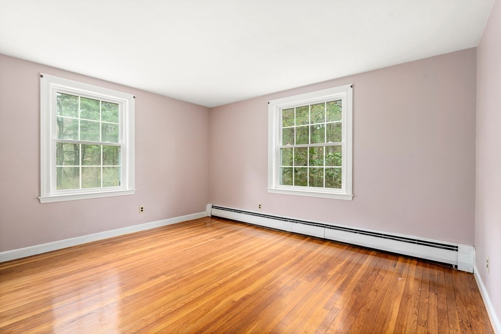 47 Stonebrook Road Sudbury, MA 01776 - Photo 12 of 17 an empty room with wooden floor and windows