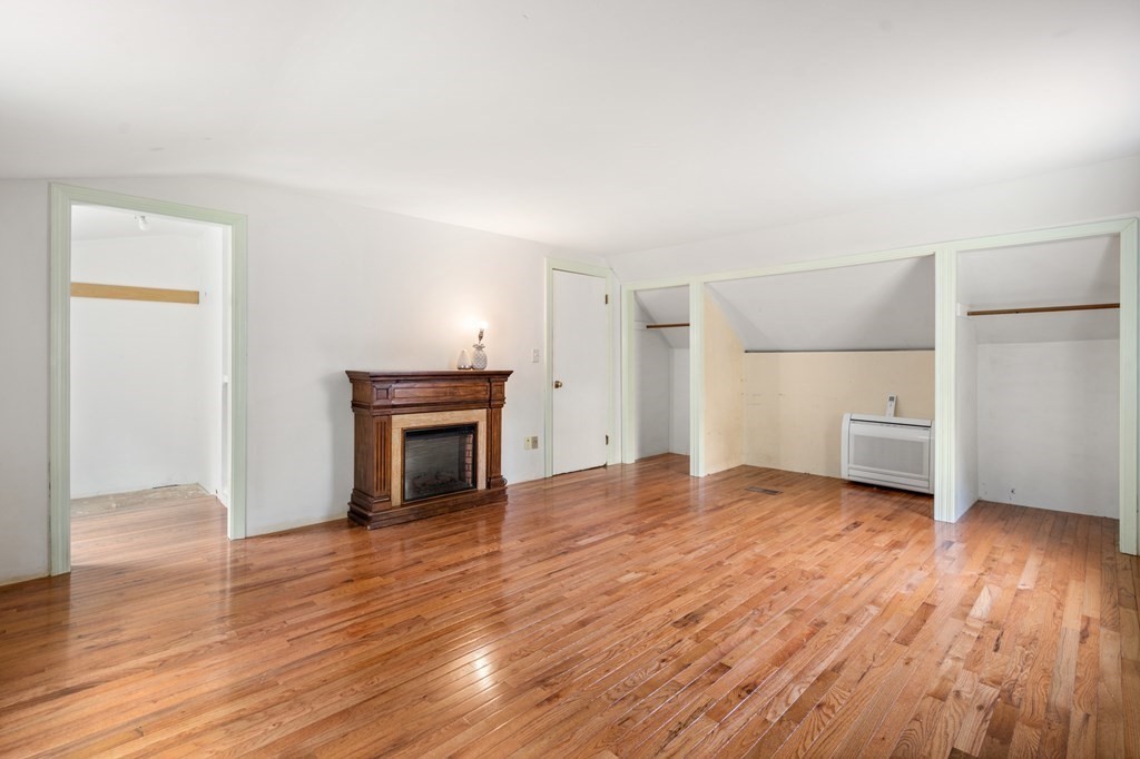 47 Stonebrook Road Sudbury, MA 01776 - Photo 13 of 17 a view of a room with wooden floor and fireplace